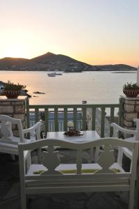 a table and chairs on a balcony with a view of the water at Villa Isabella in Naousa