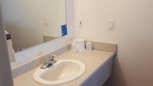 a bathroom with a sink and a mirror at Motel 6 Albany, OR in Albany +17 photos
