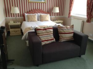 A bed or beds in a room at The Nelson Hotel 