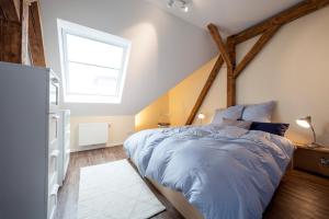 a bedroom with a large bed in a attic at Apartments LUDGERUSHOF in Bocholt