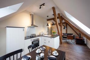a kitchen and a dining room with a table and chairs at Apartments LUDGERUSHOF in Bocholt
