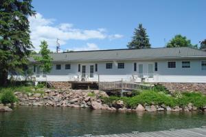 a white house with a river in front of it at Boathouse Country Inn in Rockport