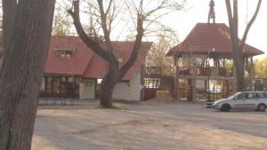 a car parked in front of a building with a gazebo at Molni in Balatonfůzfő