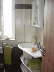 a bathroom with a white sink and a toilet at Molni in Balatonfůzfő