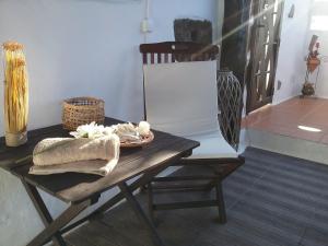 a wooden table with a chair and a towel on it at Casa Rural "La Molina" in Máguez