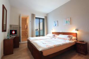 una camera da letto con un letto e una TV di Osteria Ticino by Ketty & Tommy ad Ascona