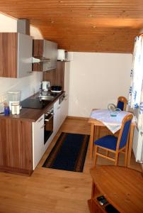 a small kitchen with a table and a counter top at Haus Schöffau in Strobl