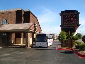 a bus parked in a parking lot next to a building at Lodge of the Ozarks in Branson