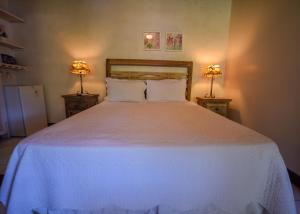 Cama ou camas em um quarto em Pousada Solar da Praia