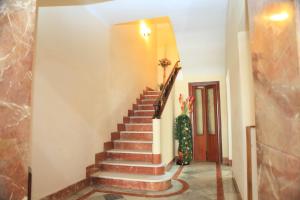 a staircase in a house with a christmas tree at Hotel El Coloso in Jerez de la Frontera