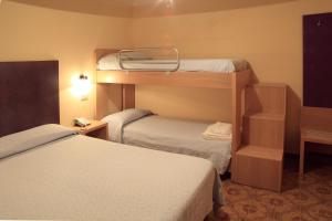 Postel nebo postele na pokoji v ubytování Hotel Grotticelle