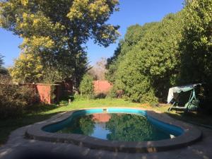 a pool in the middle of a yard with trees at La Casa Vinilla in Casablanca