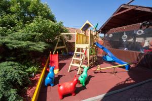 a childrens playground with a slide and a swing set at Dom Gościnny Marta in Krynica Morska