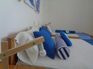 a bunk bed with blue and white pillows on it at Gaitani Studios in Lentas