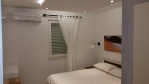 Postel nebo postele na pokoji v ubytování Gavza Luna Apartment