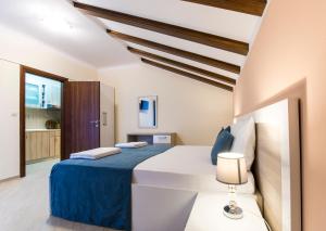 a bedroom with a large bed in a room at Jedro Apartmani in Herceg-Novi