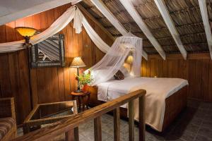 Postel nebo postele na pokoji v ubytování Chan Chich Lodge