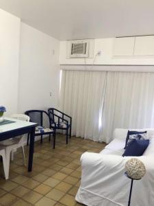 a living room with a couch and a table at Flat em Ondina (ap.404) in Salvador +25 photos