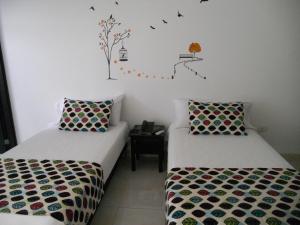 Postel nebo postele na pokoji v ubytování Hotel Cosmos Sincelejo + 37 fotografií