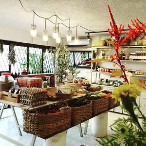 a kitchen with baskets of food on a table at Cinco Hotel B&B in San Salvador