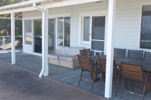 a porch with a table and chairs on a house at Loutit Views in Lorne