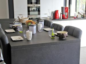 a black counter in a kitchen with glasses on it at Modish Villa in Vidauban France With Swimming Pool in Vidauban