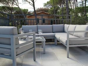 a couch and two chairs on a patio at Modish Villa in Vidauban France With Swimming Pool in Vidauban