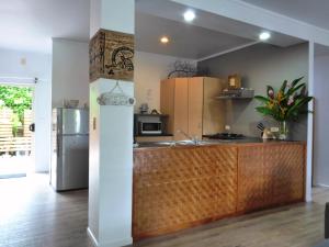 a kitchen with a sink and a refrigerator at Muri Beachside Villa with pool in Rarotonga