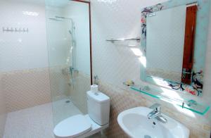 a bathroom with a toilet and a sink and a mirror at Ninh Binh Mountain View Homestay & Restaurant in Ninh Binh