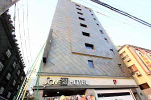 a building with a pyramid facade on a city street at Some Hotel in Busan