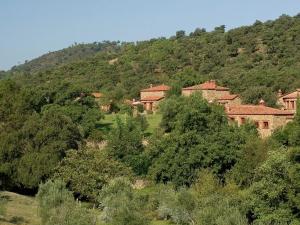 a large building in the middle of a mountain at Charming Stone Houses at Molino in Alájar