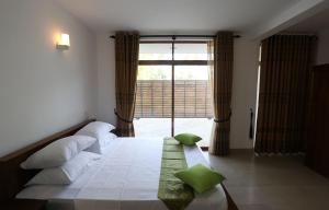 Ένα ή περισσότερα κρεβάτια σε δωμάτιο στο Aurora Residence Bentota