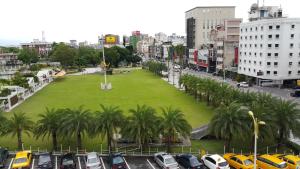 a large park with palm trees in a city at Maui B&B in Hualien City