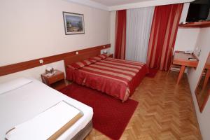 Postel nebo postele na pokoji v ubytování Hotel Narona