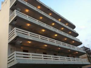 a building with white balconies and lights on it at Sakol Hotel in Nakhon Ratchasima