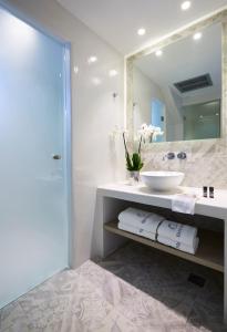 a bathroom with a sink and a mirror at Fileria Suites in Oia