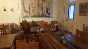 a living room with a couch and a table at Klaarstroom Guest House in Klaarstroom