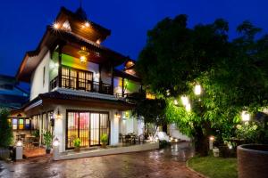 ein beleuchtetes Gebäude in der Nacht in der Unterkunft i Lanna House in Chiang Mai