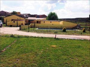 a group of buildings with a fence and a grass field at Vega de vitae in Vita