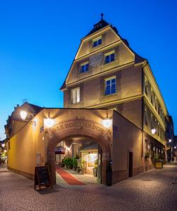 un grand bâtiment avec une arche devant lui dans l'établissement Hôtel & Spa Le Bouclier D'or, à Strasbourg