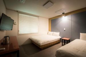 Postel nebo postele na pokoji v ubytování Champion Hotel
