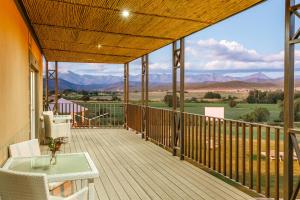 a screened porch with a view of the mountains at Surval Boutique Olive Estate in Oudtshoorn