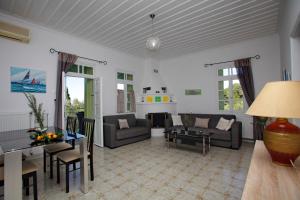 a living room with a couch and a table at Villa Liogerma in Panormos Skopelos