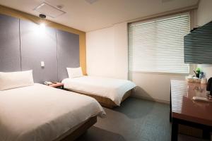 Postel nebo postele na pokoji v ubytování Champion Hotel
