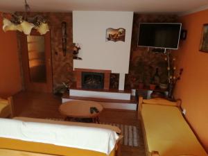 a living room with a bed and a fireplace at Privát u Zdenky in Tvrdošín