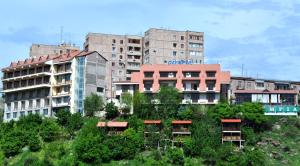 a group of buildings with trees in front of them at Olympia Garden Hotel in Yerevan