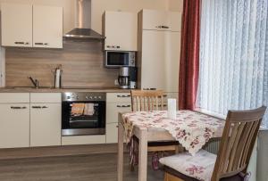 a kitchen with a table with a table cloth on it at Gästehaus Margareth in Büsum