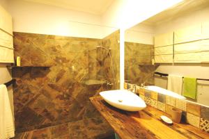 a bathroom with a toilet, sink, and bathtub at Boulevard Inn Mt Meru in Arusha