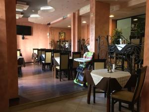 a restaurant with tables and chairs in a room at Flora Daisy Apartment nr 28 in Borovets