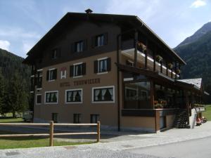 a large building with a sign on the side of it at Hotel Garni Thurwieser - B&B in Santa Caterina Valfurva